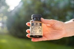 cbd oil benefits - Person incorporating CBD oil into morning wellness routine
