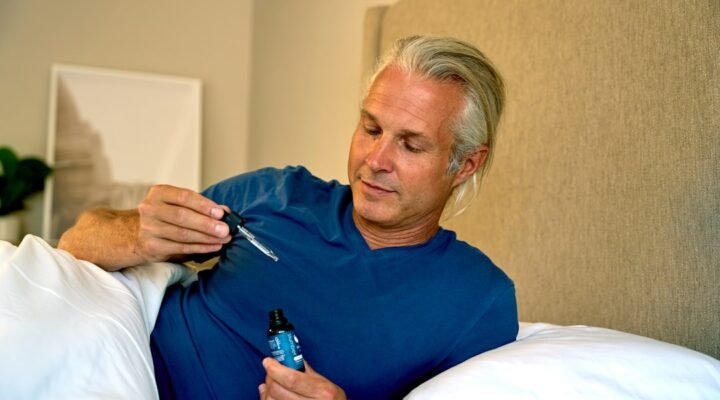 cbd oil benefits - Peaceful bedroom scene with CBD oil on nightstand