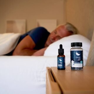 best cbd oil for sleep uk - A peaceful bedtime scene with CBD oil bottle on nightstand beside soft lighting