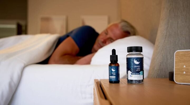best cbd oil for sleep uk - A peaceful bedtime scene with CBD oil bottle on nightstand beside soft lighting