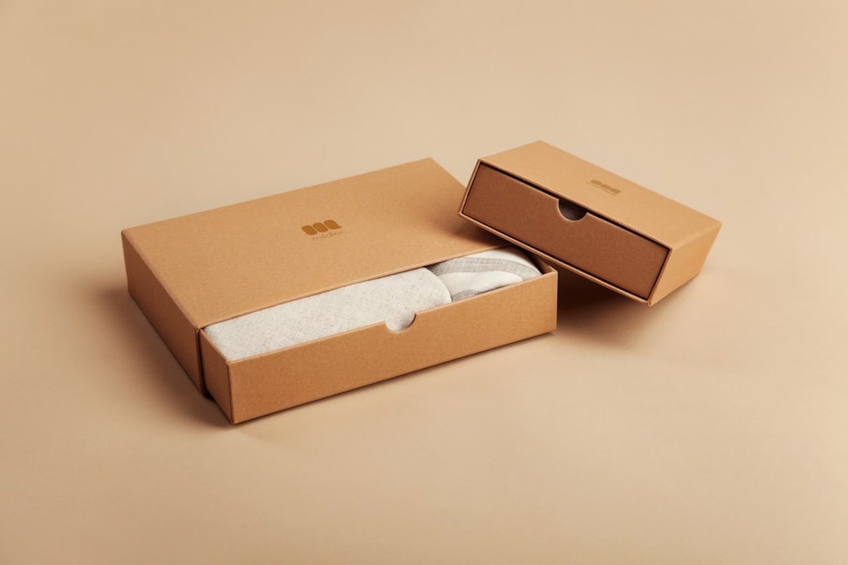 cbd packaging uk - Eco-friendly hemp-based CBD packaging materials arranged on a wooden surface